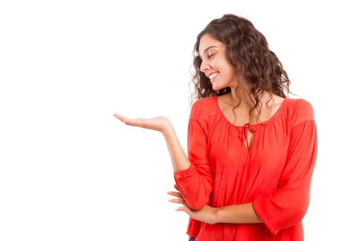 Young beautiful woman presenting your product, isolated over white background