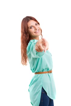 Young beautiful woman pointing at you, isolated over white