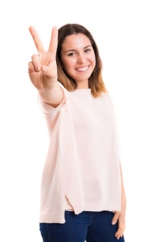 Beautiful young woman signaling ok, isolated over white