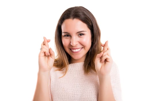 Woman with crossed fingers, isolated over a white background