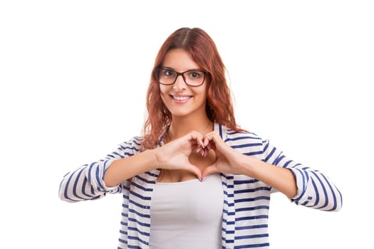 Beautiful woman making a heart shape with her hands, isolated over white background