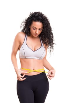 Woman measuring her body - fitness concept