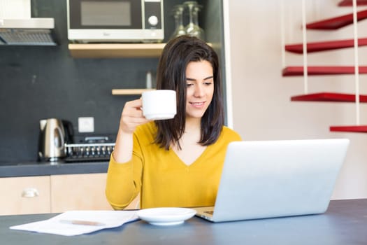 Young woman working at home in the morning