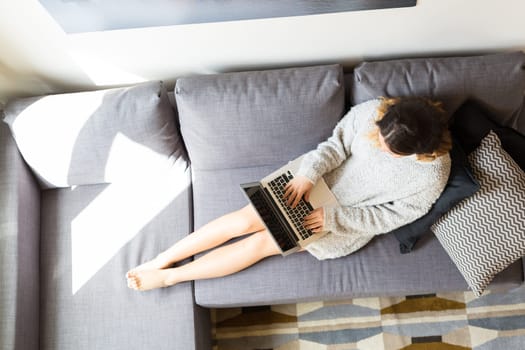 Beautiful woman relaxing with a computer