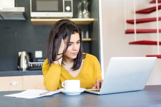 Young woman working at home in the morning