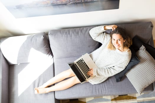 Beautiful woman relaxing with a computer