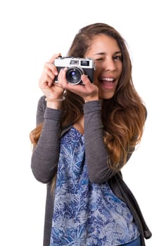 Beautiful woman holding a vintage camera, isolated over white background