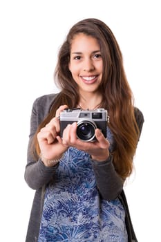 Beautiful woman holding a vintage camera, isolated over white background