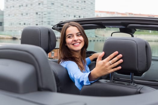 Business woman driving her new sports car