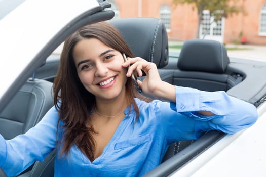 Business woman at the phone while driving