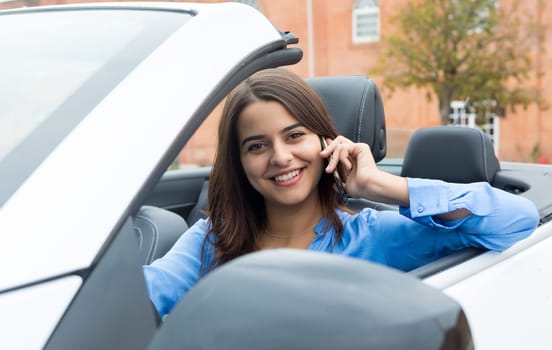 Business woman at the phone while driving