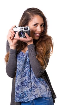 Beautiful woman holding a vintage camera, isolated over white background