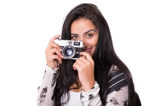 Beautiful woman holding a vintage camera, isolated over white background