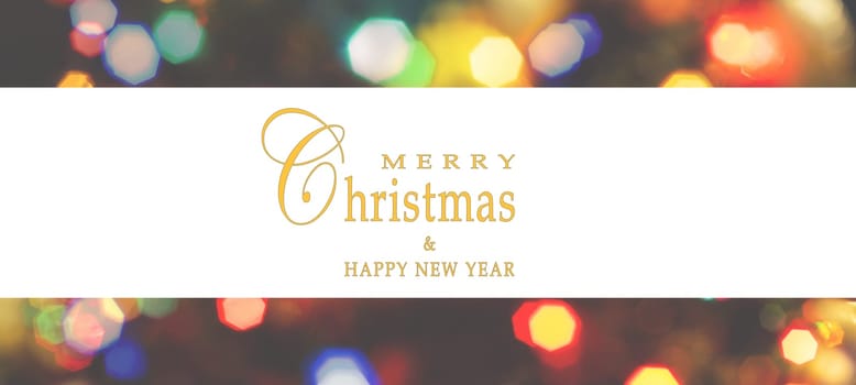 Merry Christmas and Happy New Year greeting card, blurred background of the twinkling lights of the Christmas tree. Greeting card background.