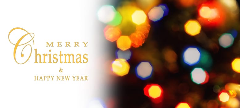 Merry Christmas and Happy New Year greeting card, blurred background of the twinkling lights of the Christmas tree. Greeting card background.