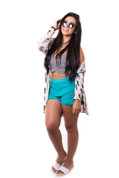 Beautiful young woman with sunglasses posing in studio, isolated over white