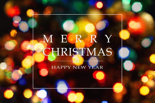Merry Christmas and Happy New Year greeting card, blurred background of the twinkling lights of the Christmas tree. Greeting card background.
