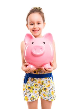 Happy young girl with a new piggy bank to start her savings