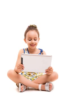 Small girl playing with her new tablet computer