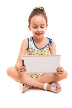 Small girl playing with her new tablet computer