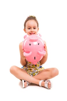 Happy young girl with a new piggy bank to start her savings
