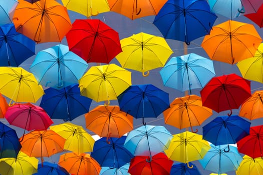 Lots of umbrellas coloring the sky in the city of Agueda, Portugal
