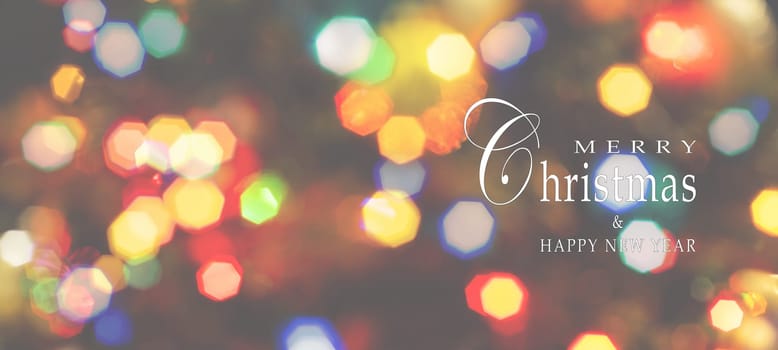 Merry Christmas and Happy New Year greeting card, blurred background of the twinkling lights of the Christmas tree. Greeting card background.