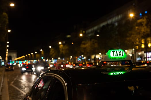French taxi with the champs elysees avenue in background