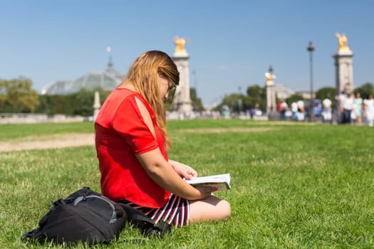Lucky girl relaxing in the gardens next to the Invalides and the Alexander the 3rd bridge in Paris