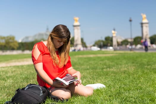 Lucky girl relaxing in the gardens next to the Invalides and the Alexander the 3rd bridge in Paris