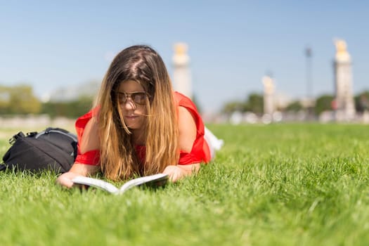 Lucky girl relaxing in the gardens next to the Invalides and the Alexander the 3rd bridge in Paris