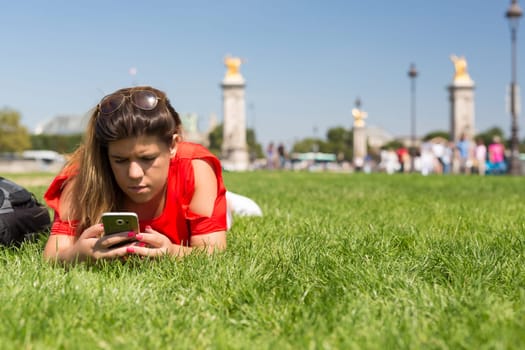 Lucky woman in Paris checking her smartphone for news