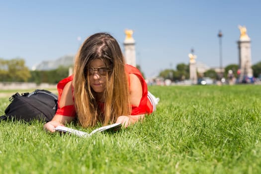 Lucky girl relaxing in the gardens next to the Invalides and the Alexander the 3rd bridge in Paris