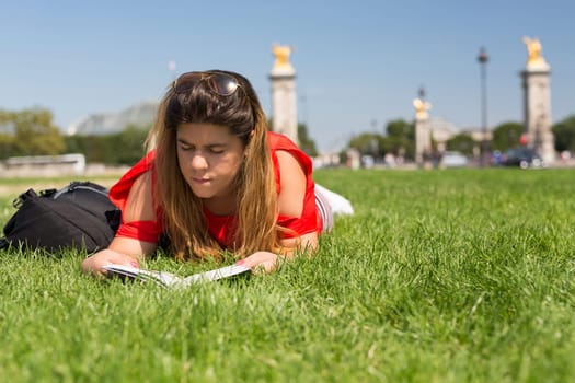 Lucky girl relaxing in the gardens next to the Invalides and the Alexander the 3rd bridge in Paris