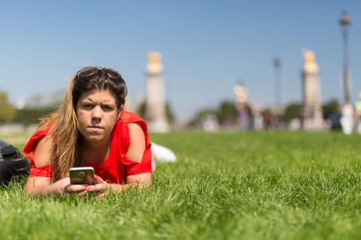 Lucky woman in Paris checking her smartphone for news