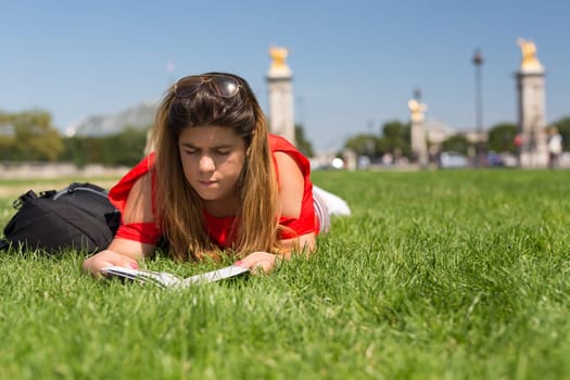 Lucky girl relaxing in the gardens next to the Invalides and the Alexander the 3rd bridge in Paris