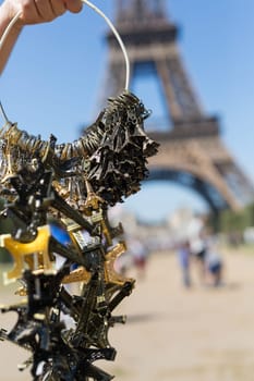 Woman selling small Eiffel Towers in the gardens of the Eiffel Tower, the main attraction in Paris, France