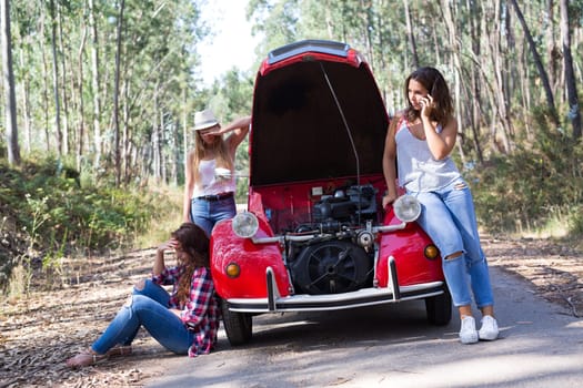 Friends on a roadtrip having a problem with their old car