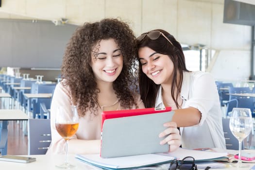 Group of happy students preparing their exams or simply relaxing at a bar