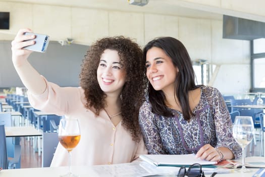 Group of happy students preparing their exams or simply relaxing at a bar
