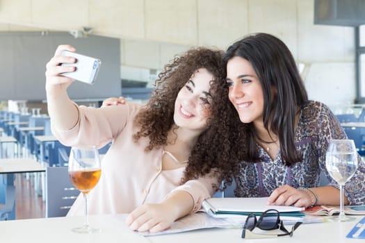 Group of happy students preparing their exams or simply relaxing at a bar