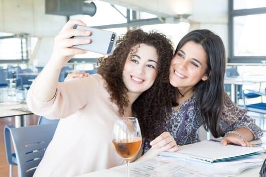 Group of happy students preparing their exams or simply relaxing at a bar