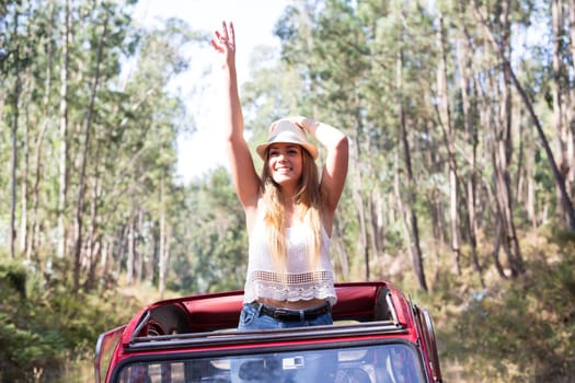 Woman going on a roadtrip in her convertible car