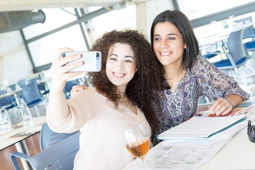 Group of happy students preparing their exams or simply relaxing at a bar