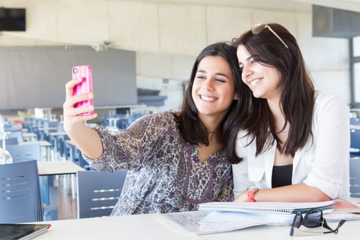 Group of happy students preparing their exams or simply relaxing at a bar