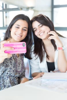 Group of happy students preparing their exams or simply relaxing at a bar
