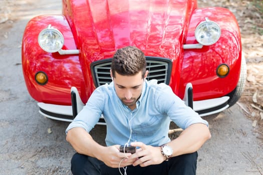 Young man resting at car trip by the countryside