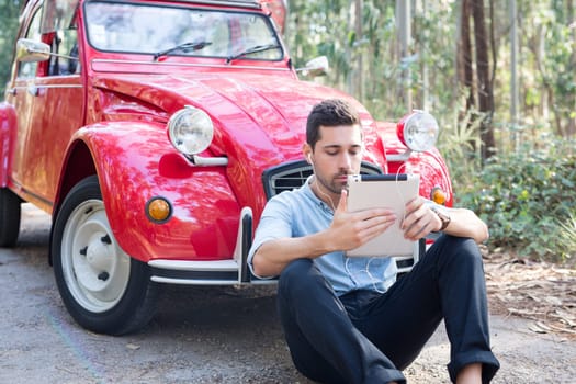 Young man resting at car trip by the countryside