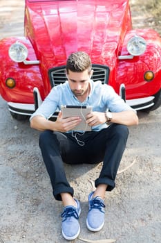 Young man resting at car trip by the countryside