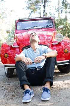 Young man resting at car trip by the countryside